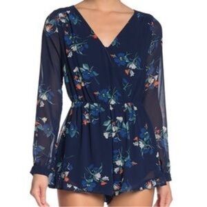 NWOT Revolve Japna Blue Floral splice ruffle hem Romper. Size Small